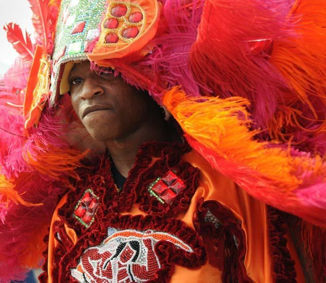 A Mardi Gras Indian walks between stages Saturday, April 27, 2013 at the New Orleans Jazz &amp; Heritage Festival on the Fair Grounds Race Course.
 