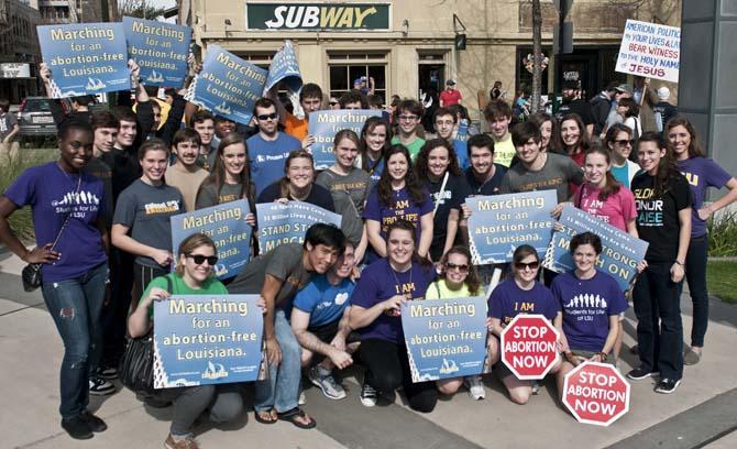 The LSU-based organiztion, Students for Life, pose Saturday, Jan. 12, 2013, with their pro-life signs. They marched with approximately 3,000 other protesters from the Old State Capitol to the New State Capitol.
 