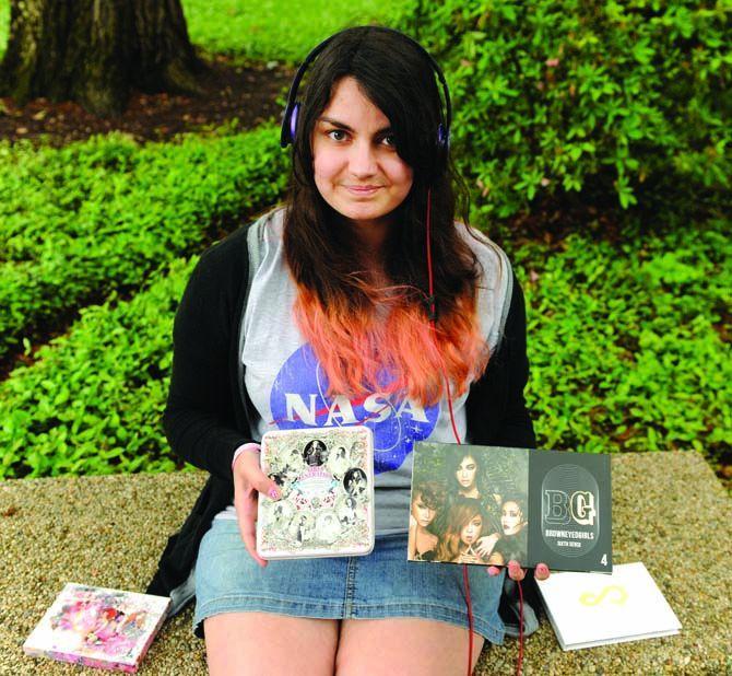 History freshman Emerson Spano displays her Korean pop albums April 24, 2013, in the quad.
 