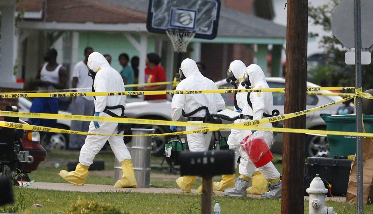 Federal authorities wearing hazmat suits walk to the home of Everett Dutschke for additional investigation, Tuesday evening, April 23, 2013 in Tupelo, Miss., in connection with the recent ricin attacks. No charges have been filed against Dutschke and he hasn&#8217;t been arrested. (AP Photo/Rogelio V. Solis)