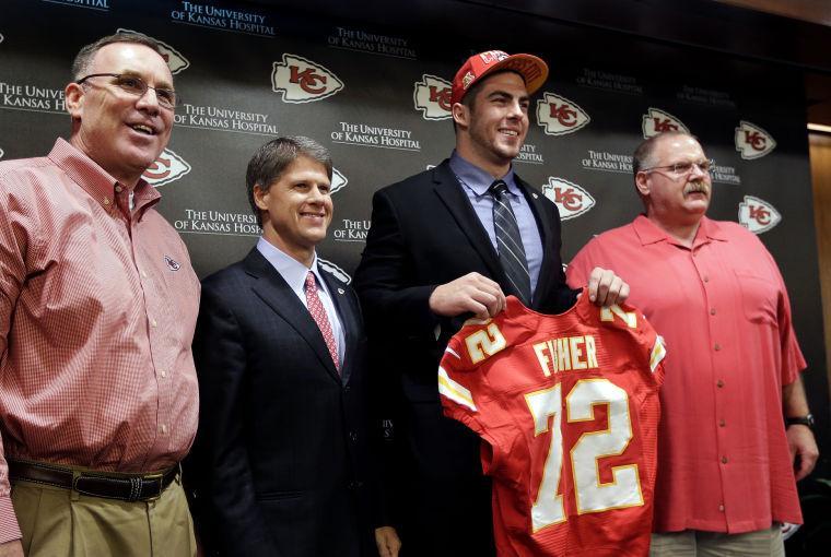 Kansas City Chiefs No. 1 draft pick Eric Fisher, an offensive lineman from Central Michigan, poses with general manager John Dorsey, left, coach Andy Reid, right, and owner Clark Hunt during an NFL football news conference Friday, April 26, 2013, in Kansas City, Mo. Fisher was the No. 1 overall pick in the NFL draft on Thursday. (AP Photo/Charlie Riedel)
 