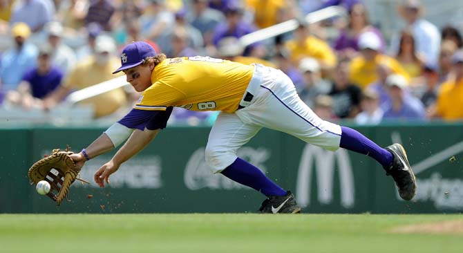 LSU senior first baseman Mason Katz (8) dives to catch the ball Sunday, April 7, 2013 during the Tigers' 11-4 victory against Kentucky in Alex Box Stadium.
 