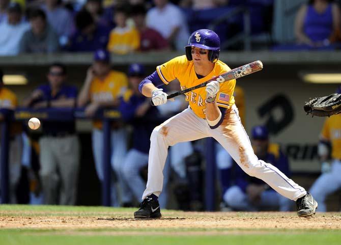 LSU freshman outfielder Mark Laird (9) hits the ball Sunday, April 7, 2013 during the Tigers' 11-4 victory against Kentucky in Alex Box Stadium.
 