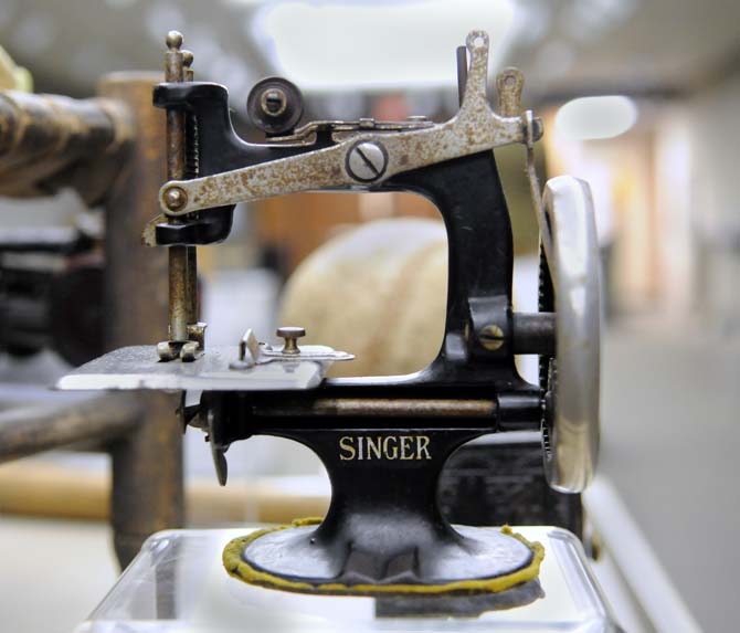 An antique Singer brand sewing machine stands on display in the LSU Union Art Gallery as a part of the showing titled A Slice of South Louisiana.
 