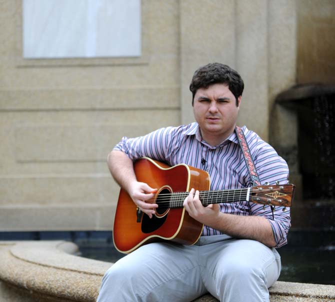 Matt Sigur, an acoustic guitar soloist, plays his guitar in front of the fountain in the quad Tuesday, April 30, 2013.
 