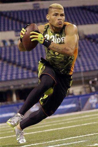 Louisiana State defensive back Tyrann Mathieu runs a drill during the NFL football scouting combine in Indianapolis, Tuesday, Feb. 26, 2013. (AP Photo/Dave Martin)
 