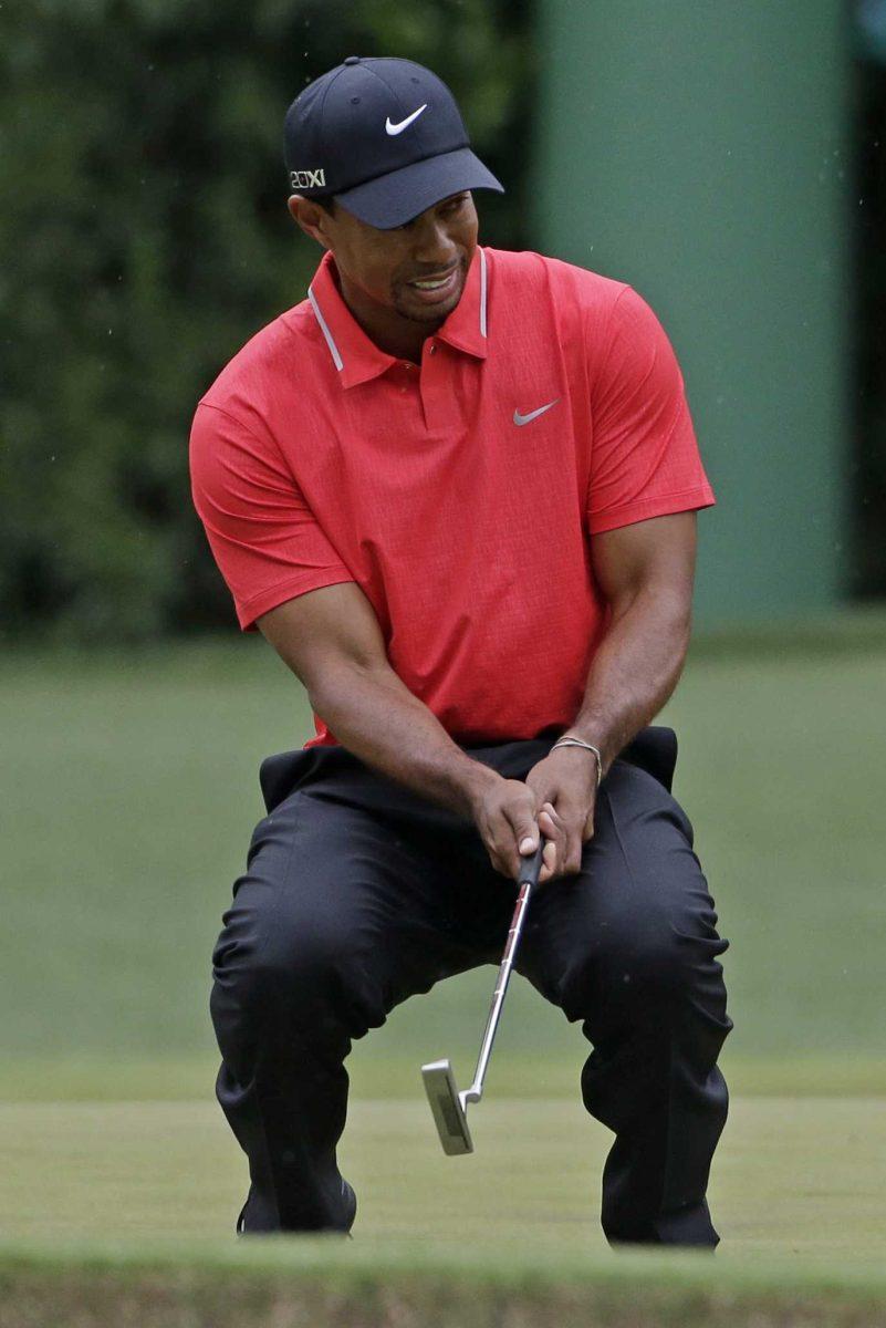 Tiger Woods reacts after missing a putt on the fourth green during the fourth round of the Masters golf tournament Sunday, April 14, 2013, in Augusta, Ga. (AP Photo/Darron Cummings)