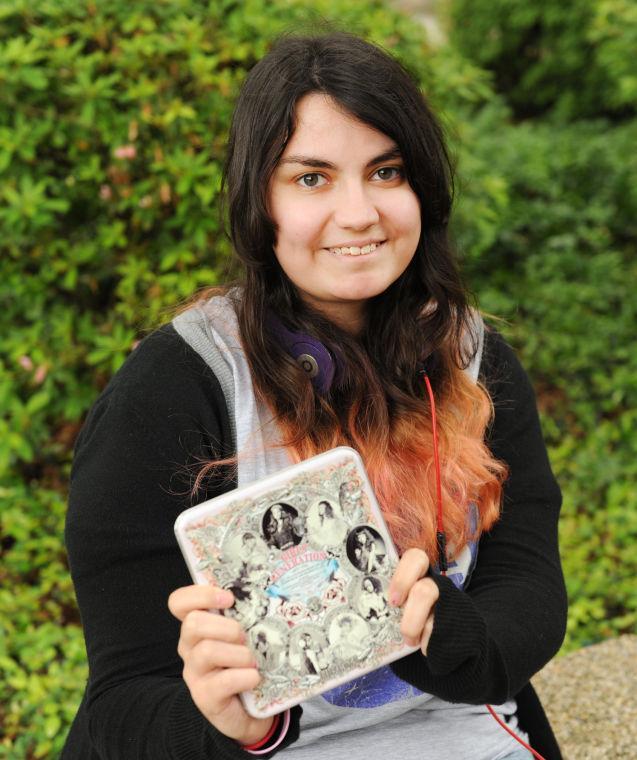 History freshman Emerson Spano displays one of her Korean pop albums April 24, 2013, in the quad.
 