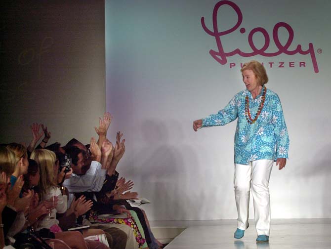 FILE - In this Saturday Sept. 21, 2002, file photo, Lilly Pulitzer reacts to cheers after the showing of her spring 2003 fashions in New York, 2002. P ulitzer, known for her tropical print dresses, died in Florida at 81 on Sunday, April, 7, 2013. ( (AP Photo/Bebeto Matthews)
 