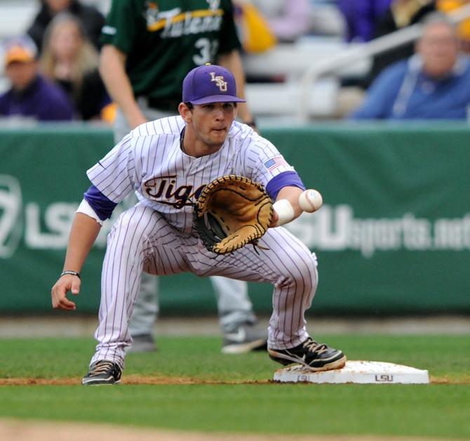 LSU sophomore infielder Tyler Moore (2) receives a throw for an out Wednesday, April 24, 2013 during the Tigers' 4-3 victory over Tulane at Alex Box Stadium.
 