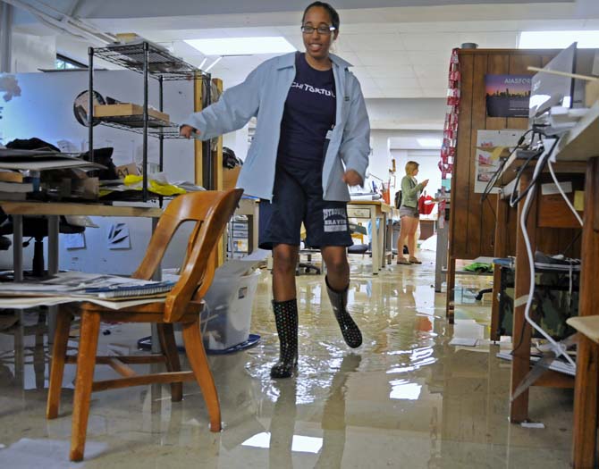 Teresa Williams, third year architecture student, walks through the flooded student studio space Wednesday, April 24, 2013 in the basement of Atkinson Hall.
 