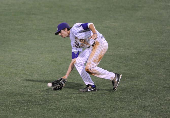 LSU freshman outfileder Mark Laird picks up the ball Tuesday, April 30, 2013, during the Tigers' 7-3 win against the MSU Cowboys.
 