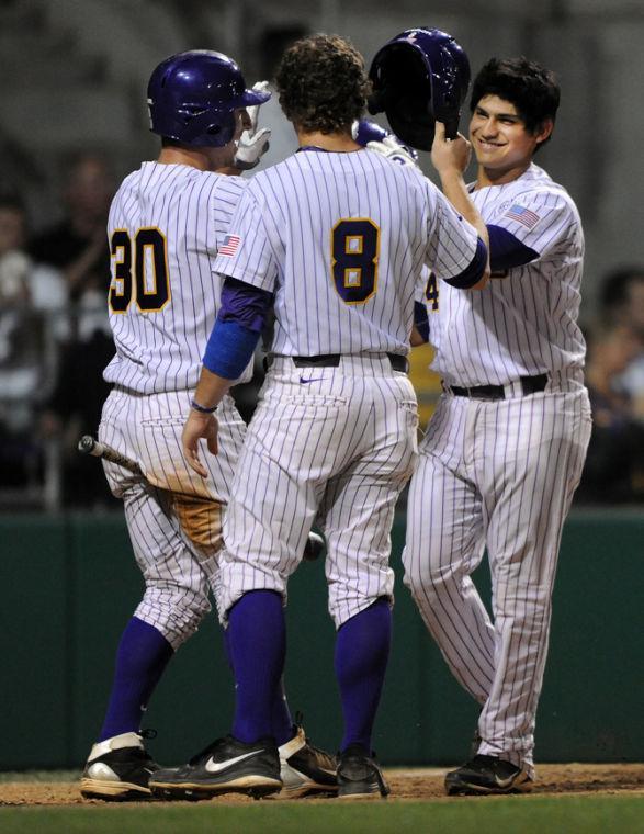 LSU junior third baseman Christian Ibarra (14) celebrates with senior first baseman Mason Katz (8) and freshman short stop Alex Bregman (30) Wednesday, April 10, 2013 during the 16-2 victory over Southern University at Alex Box Stadium.
 