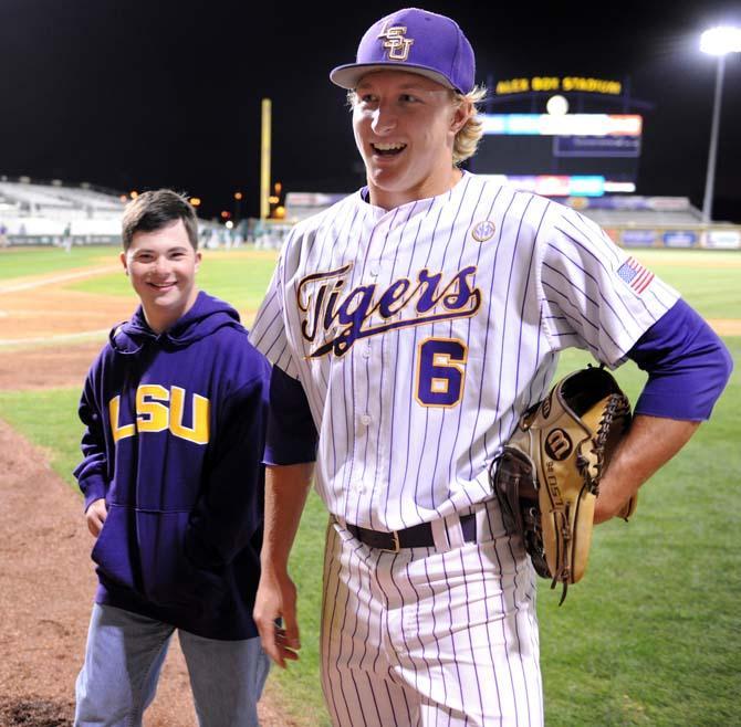 LSU freshman outfielder Andrew Stevenson (6) and his brother Matt take the field after the Tigers' 4-3 victory over Tulane at Alex Box Stadium.
 