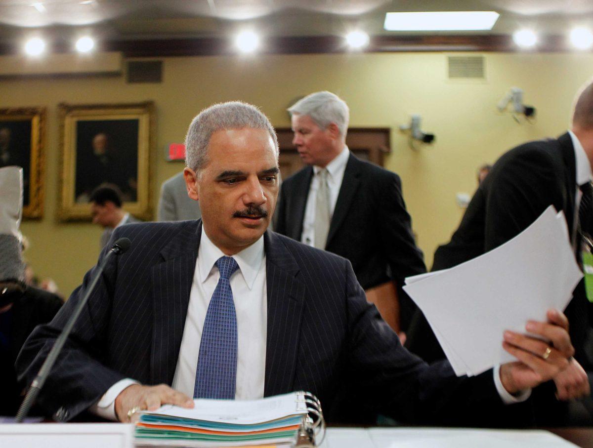 Attorney General Eric Holder prepares to testify on Capitol Hill in Washington, Thursday, April 18, 2013, before the House Appropriations Committee hearing on the Justice Department's fiscal 2014 budget. (AP Photo/Molly Riley)