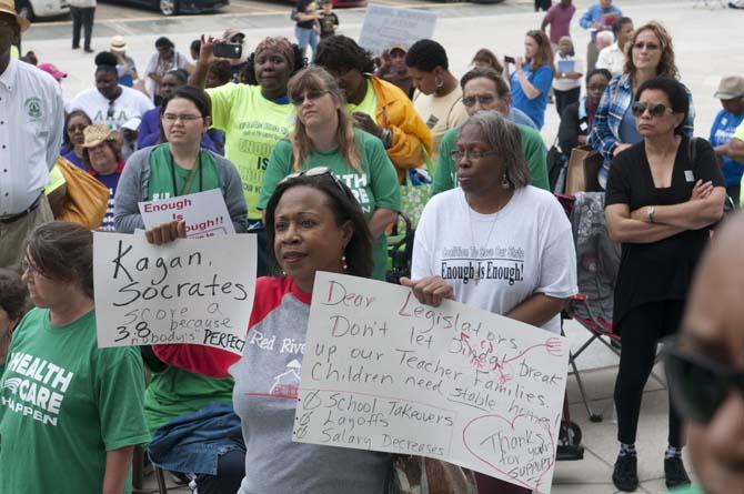 Debbie Ball of Benton, La, holds signs Tuesday, April 30, 2013, at the March on Baton Rouge on the State Capitol Steps.
 