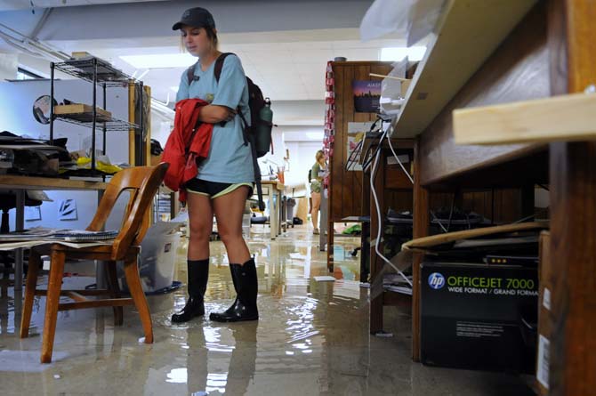 Mallory Estopinal, third year architecture student, walks through the flooded student studio space Wednesday, April 24, 2013 in the basement of Atkinson Hall.
 