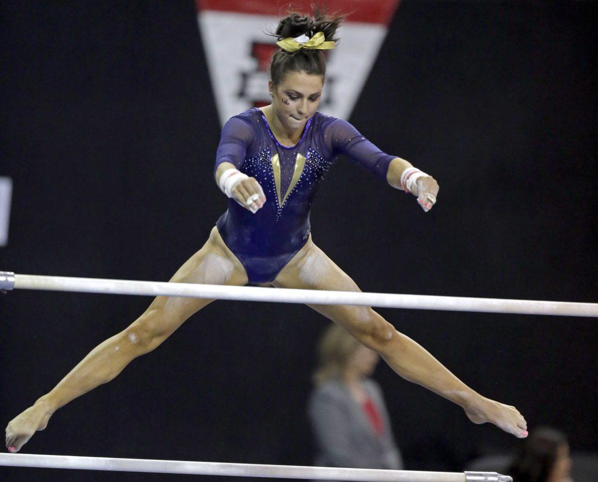 LSU's Rheagan Courville competes in the uneven parallel bars in the NCAA women's gymnastics championships in Los Angeles on Saturday, April 20, 2013. (AP Photo/Reed Saxon)