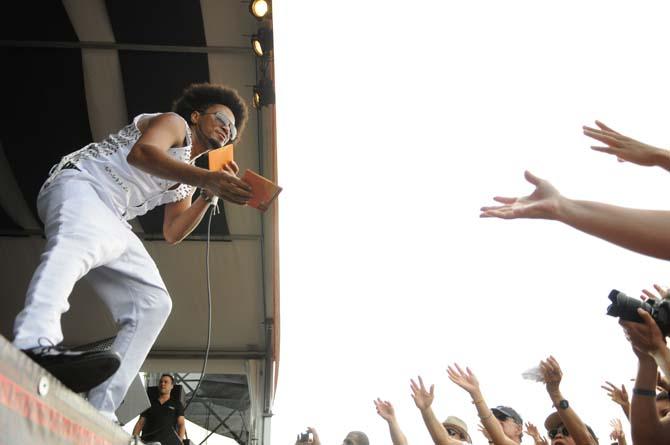 Magary Lord of Bahia-Brazil throws CDs to the crowd Saturday, April 27, 2013 at the New Orleans Jazz &amp; Heritage Festival on the Fair Grounds Race Course.
 