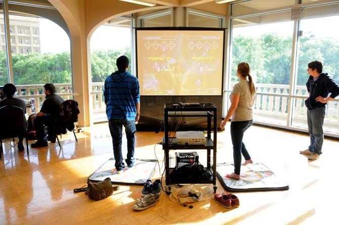 Two students play Dance Dance Revolution at Rescon 2013 Monday, April 29, 2013. There were other video games and tabletop games, such as board and card games, available at the event.
 