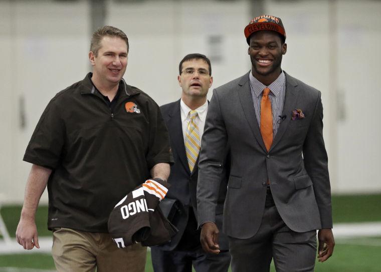 Cleveland Browns head coach Rob Chudzinski, left, and first round draft pick linebacker Barkevious Mingo, right, walk to a news conference at the NFL football team's practice facility in Berea, Ohio Friday, April 26, 2013. Mingo, from LSU, was selected sixth overall in Thursday's NFL draft. (AP Photo/Mark Duncan)
 