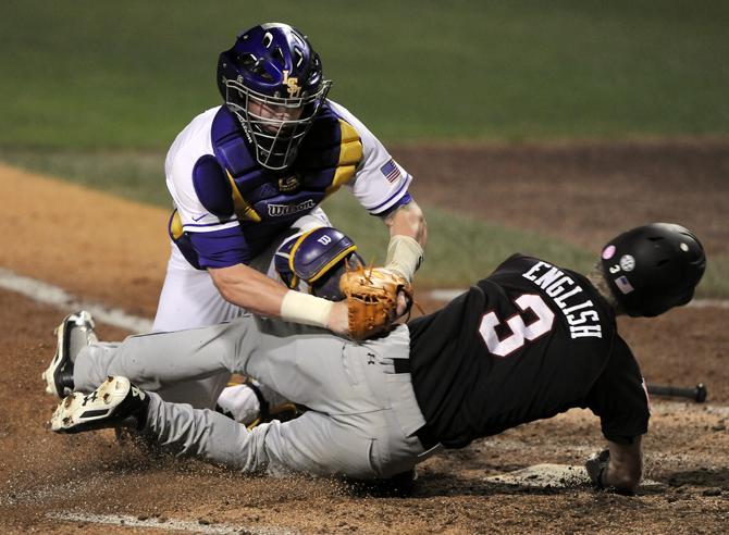 LSU junior catcher Ty Ross (26) tags South Carolina out fielder Tanner English out at the plate Friday, April 26, 2013 during the Tigers' 5-2 victory over South Carolina at Alex Box Stadium.
 