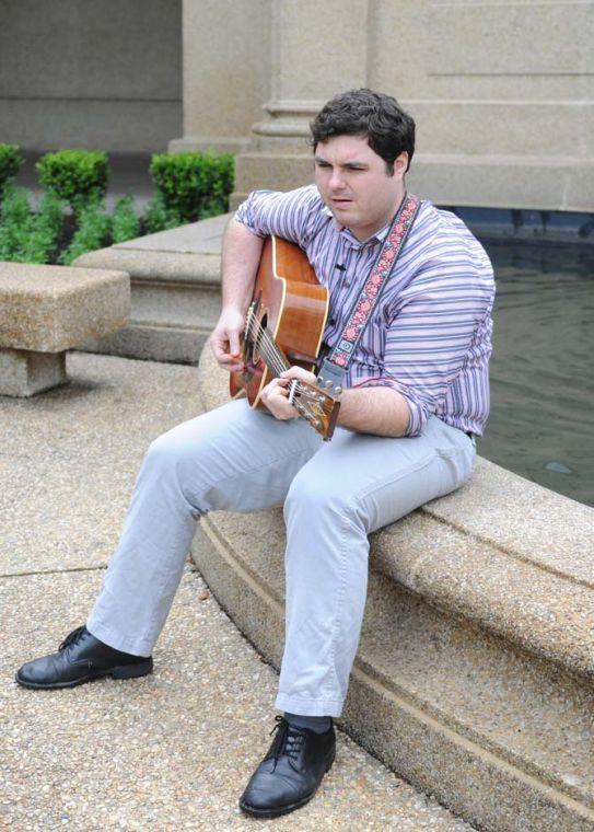 Matt Sigur, an acoustic guitar soloist, plays his guitar in front of the fountain in the quad Tuesday, April 30, 2013.
 