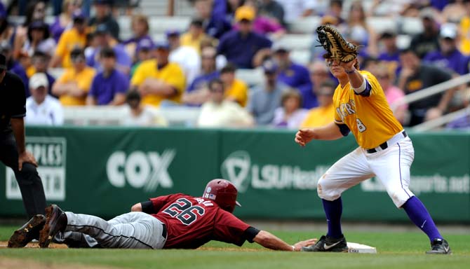 LSU senior first-baseman Mason Katz (8) catches the ball as South Carolina junior Graham Saiko (26) slides into first base April 28, 2013 during LSU's 4-0 lost to South Carolina in Alex Box Stadium.