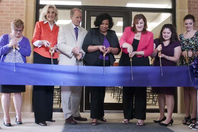 Stuart Bell, vice chancellor and provost (third from left), Katrice Albert, vice provost for Equity, Diversity, and Community Outreach (center) and other individuals involved in the creation of the new Women's Center cut the ribbon Thursday, May 2, 2013.
 