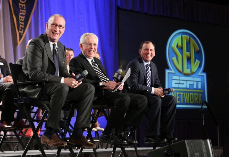 ESPN president John Skipper, left, SEC commissioner Mike Slive, center, and ESPN Senior Vice President of Programing Justin Connolly, right, answer questions from the media during a news conference announcing the launching of the Southeastern Conference Network in partnership with ESPN, Thursday, May 2, 2013, in Atlanta. The network will produce 1,000 live events each year, including 450 televised on the network and 550 distributed digitally. (AP Photo/Atlanta Journal-Constitution, Jason Getz)
 