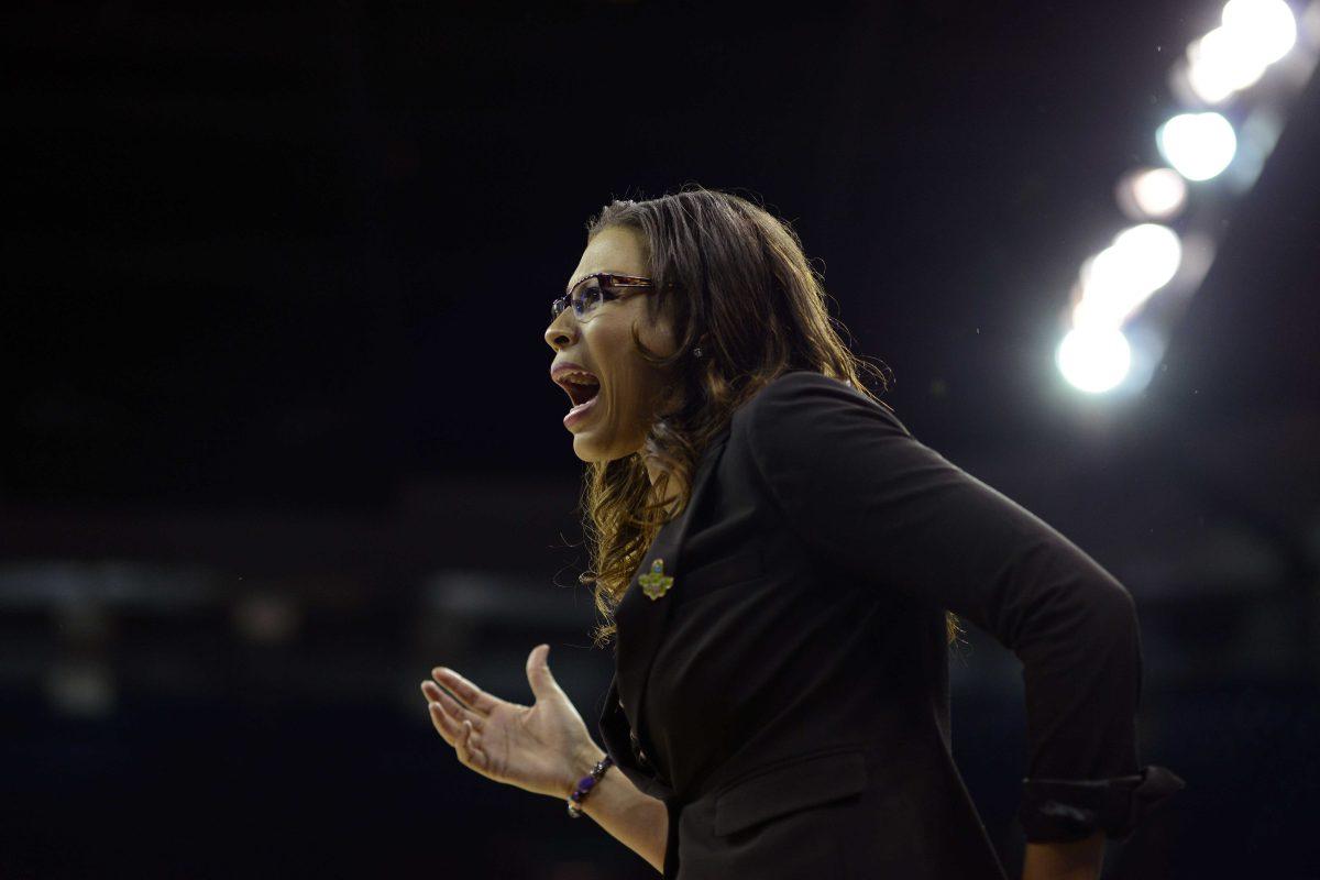 LSU's head coach Nikki Caldwell exchanges words with an official in the first half of a regional semifinal game against California in the NCAA women's college basketball tournament, Saturday March 30, 2013 in Spokane, Wash. (AP Photo/Jed Conklin)