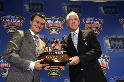 Heisman Trophy winner and Texas A&amp;M quarterback Johnny Manziel, left, poses with former NFL quarterback Archie Manning and the the Manning Award, which Manziel will be receiving as the nation's top quarterback, Thursday, May 2, 2013, in New Orleans. (AP Photo/Gerald Herbert)
 