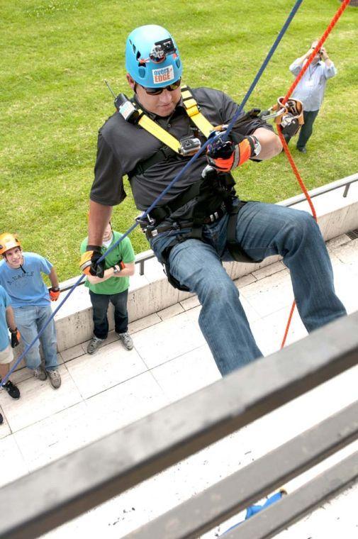 LSU coach Les Miles practices his rappelling technique at the base of the Capitol One building Thursday, May 30, 2013 before his rappel down the 24 story structure in downtown Baton Rouge. Miles' descent is in effort to raise awareness for Louisiana children available for adoption.
 