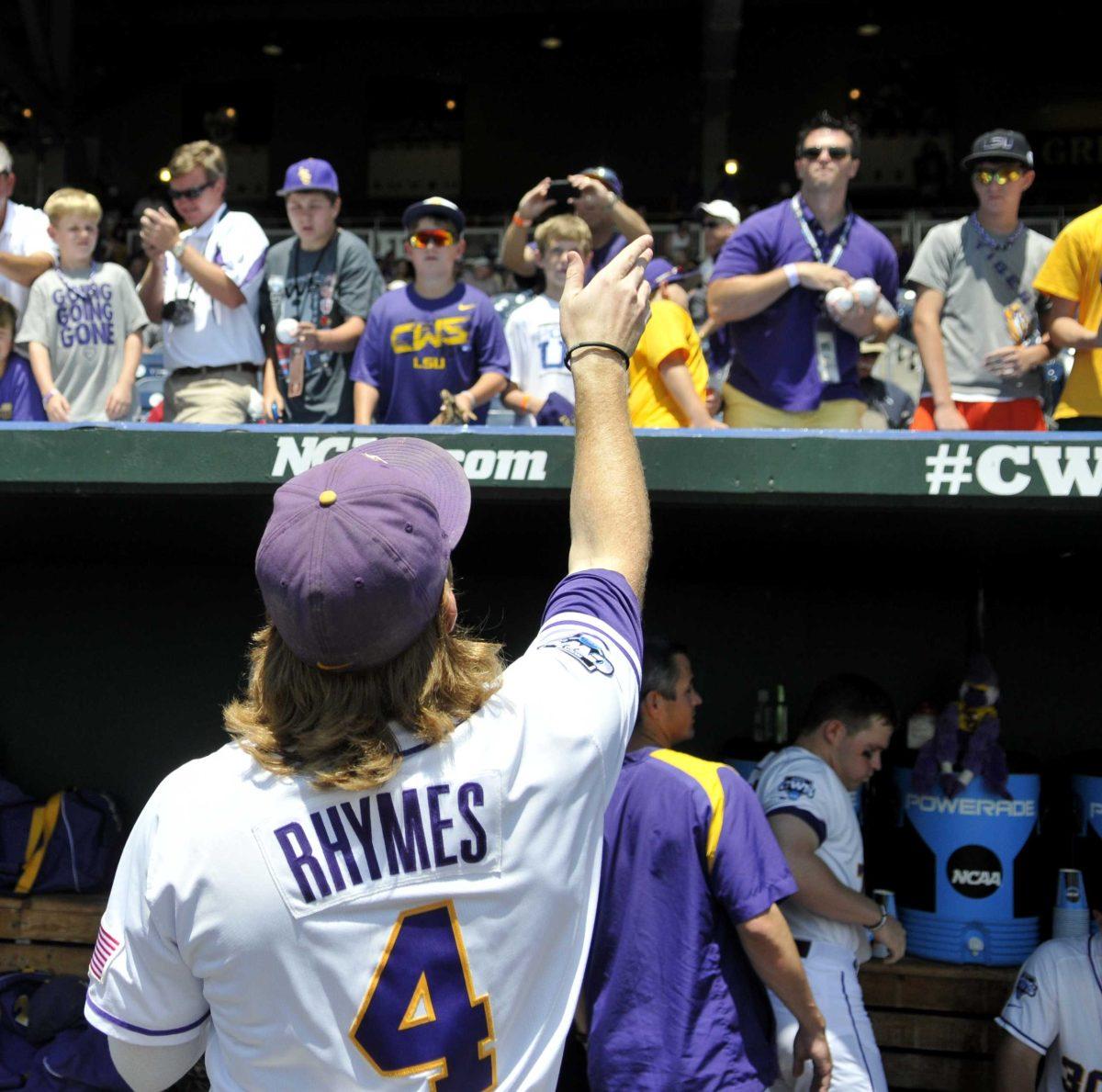 LSU senior outfielder Raph Rhymes (4) reaches out to catch a ball from a fan before LSU's 2-4 loss to UNC June 18, 2013 at the College World Series in TD Ameritrade Park.