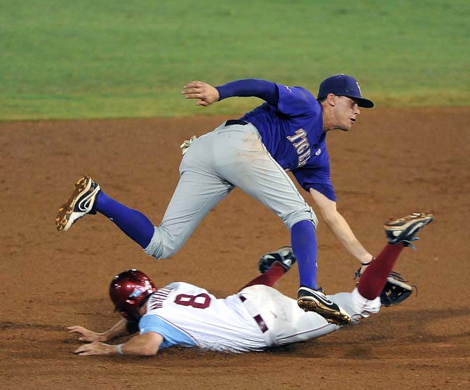 LSU junior infielder JaCoby Jones (23) tries to tag Oklahoma senior infielder Jack Mayfield (8) June 8, 2013 during the Tigers' 11-1 win against the Sooners in Alex Box Stadium.
 