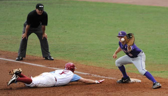 LSU senior infielder Mason Katz (8) tries to tag out Oklahoma senior outfielder Max White (7) June 8, 2013 during the Tigers' 11-1 win against the Sooners in Alex Box Stadium.
 