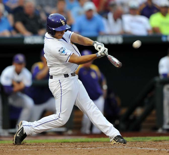 LSU junior infielder Christian Ibarra (14) hits the ball June 16, 2013 during LSU's 2-1 loss against UCLA at the College World Series in TD Ameritrade Park.
 