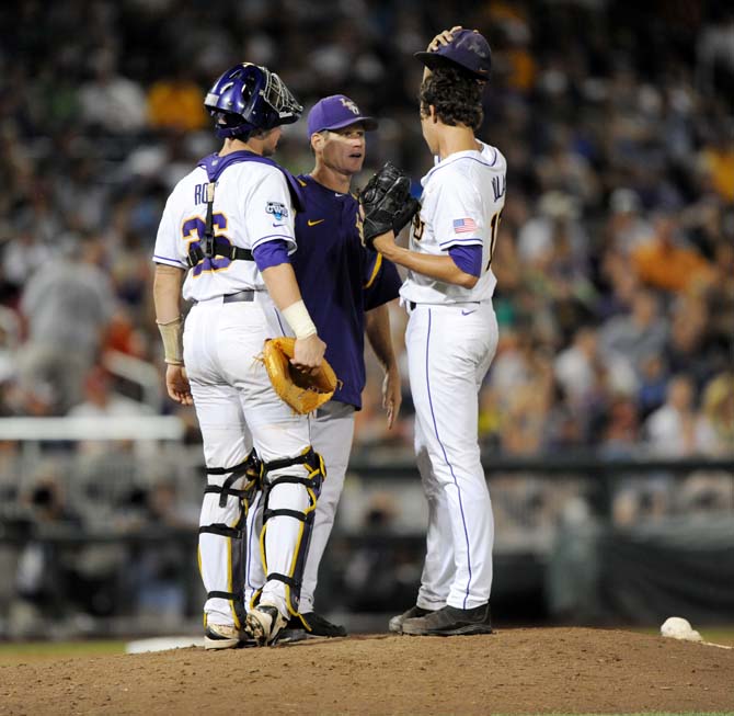 LSU pitching coach Alan Dunn speaks with sophomore right-handed pitcher Aaron Nola (10) and junior catcher Ty Ross (26) June 16, 2013 during LSU's 2-1 loss against UCLA at the College World Series in TD Ameritrade Park.
 