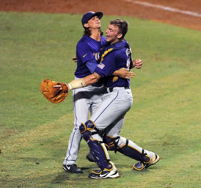 LSU junior catcher Ty Ross (26) embraces senior closer Chris Cotton (58) following the last out of the Tigers' 11-1 Super Regional victory against Oklahoma in Alex Box Stadium.
 