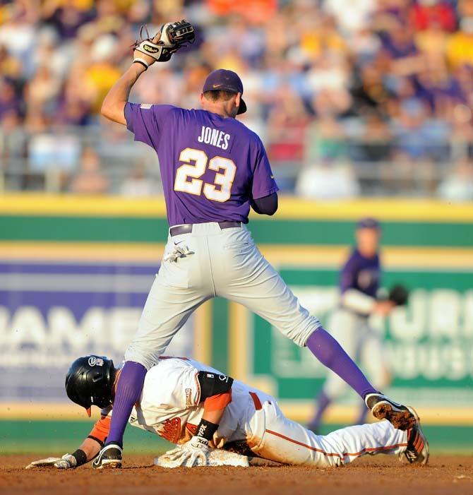 LSU junior infielder JaCoby Jones (23) stands over Sam Houston senior infielder Kevin Miller (4) June 1, 2013 during the Tigers' 8-5 win against the Bearkats.
 