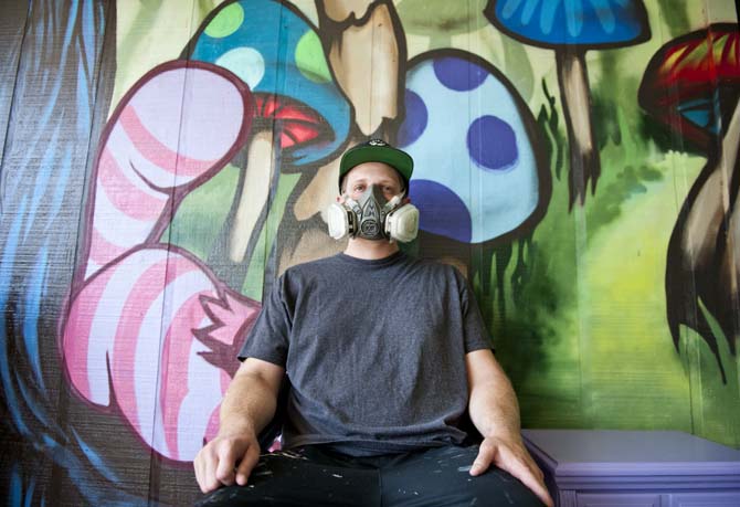 Marc Verret, also known as Marc Fresh, wears a ventilation mask in his outdoor workstation Monday, June 10, 2013 at his home in East Baton Rouge Parish. Verret uses the mask when painting large pieces of street art that involve spray paint fumes.
 