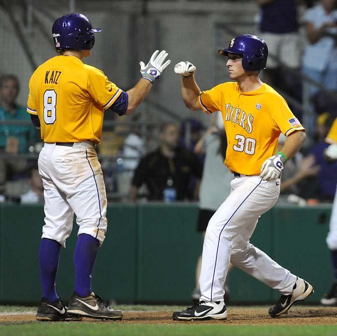 LSU senior infielder Mason Katz (8) congratulates freshman infielder Alex Bregman (30) June 2, 2013 after Bregman's solo home run put the Tigers up 5-1 over ULL in Alex Box Stadium.
 