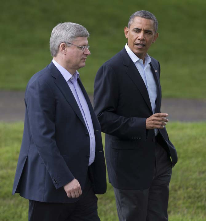 Canadian Prime Minister Stephen Harper walks with US President Barack Obama during the G8 Summit at Lough Erne near Enniskillen, Northern Ireland, Tuesday, June 18, 2013. (AP Photo/The Canadian Press, Adrian Wyld)