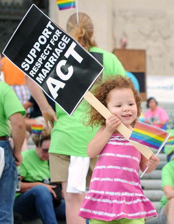 Teya Feinauer, 3, holds an equal rights sign June 15, 2013 at a Pride Rally in downtown Baton Rouge.
 