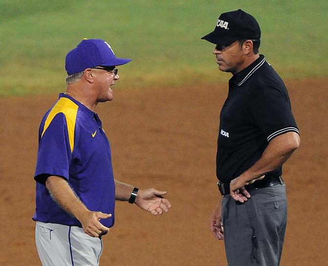 LSU head baseball coach Paul Mainieri (left) argues with second base umpire Billy Haze (right) during the Tigers' 11-1 win against Oklahoma in Alex Box Stadium.
 