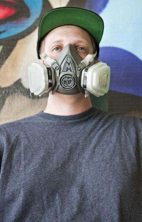 Marc Verret, also known as Marc Fresh, wears a ventilation mask in his outdoor workstation Monday, June 10, 2013 at his home in East Baton Rouge Parish. Verret uses the mask when painting large pieces of street art that involve spray paint fumes.
 