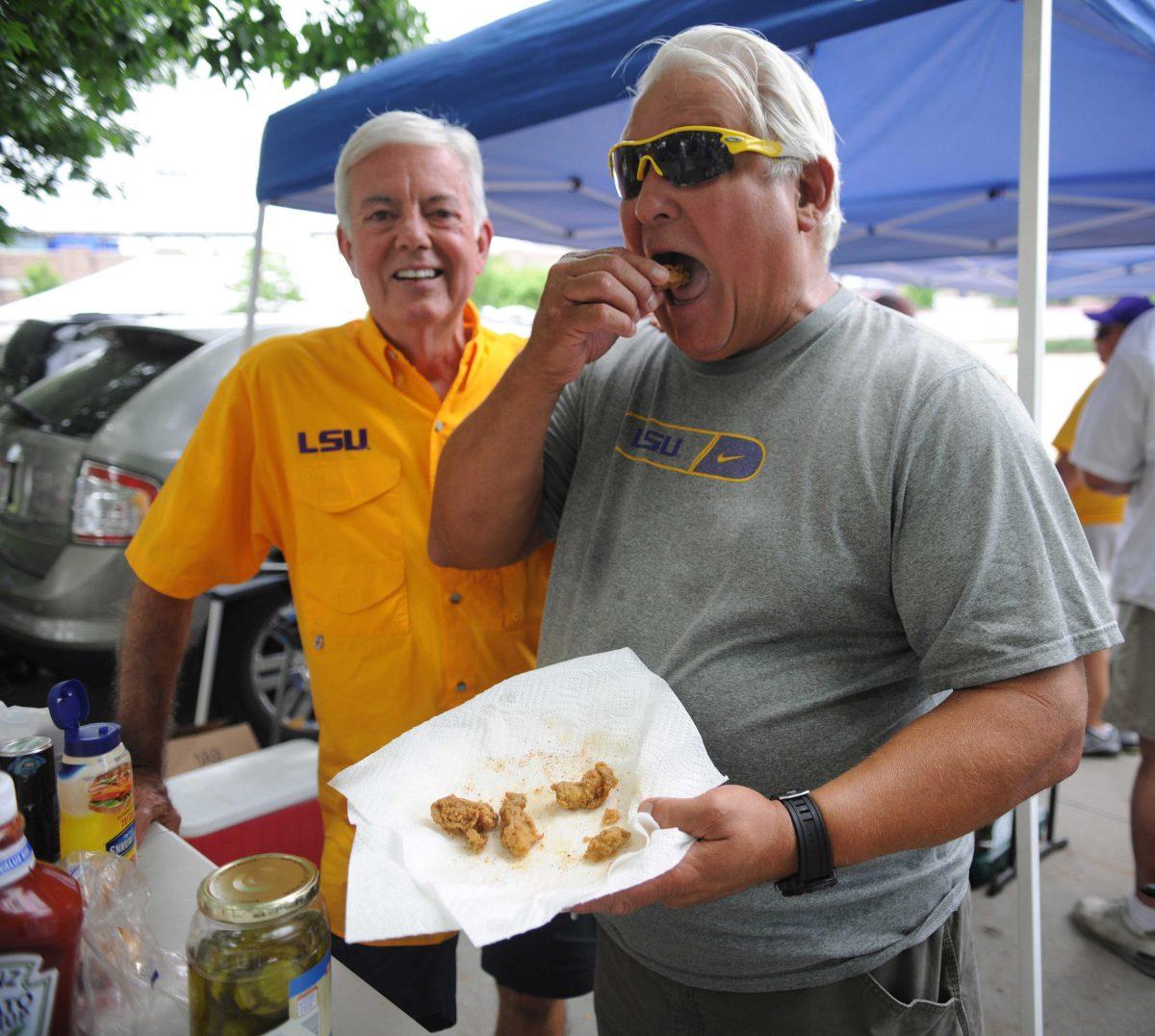 New Orleans native, Mike Serio, eats freshly cooked fried shrimp at his tailgate June 16, 2013 before the LSU vs. UCLA game at the College World Series outside of TD Ameritrade Park in Omaha, Nebraska.