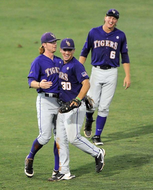 LSU freshman outfielder Andrew Stevenson (6) laughs as infielder Alex Bregman (30) and senior outfielder Raph Rhymes (4) embrace June 1, 2013 during the Tigers' 8-5 win against Sam Houston. In the previous game against Jackson State, Rhymes and Bregman collided while trying for the same ball and were removed from the matchup with injuries.
 