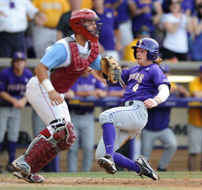 LSU senior outfielder Raph Rhymes (4) slides into home plate June 8, 2013 during the Tigers' 11-1 win against Oklahoma in Alex Box Stadium.
 