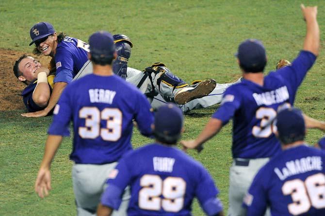 LSU senior closer Chris Cotton (58) and junior catcher Ty Ross (26) smile at their approaching teammates June 8, 2013 during the Tigers' 11-1 win against Oklahoma in Alex Box Stadium.
 